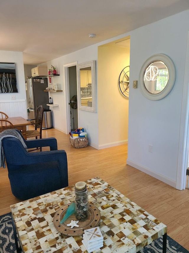 living room with baseboards and light wood-style floors