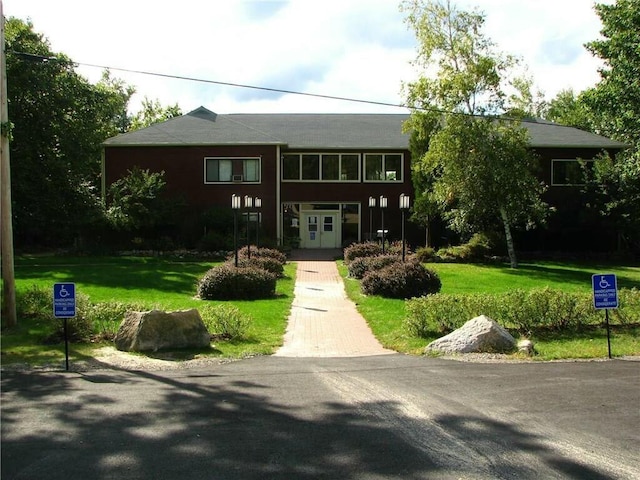 view of front of house featuring french doors and a front yard