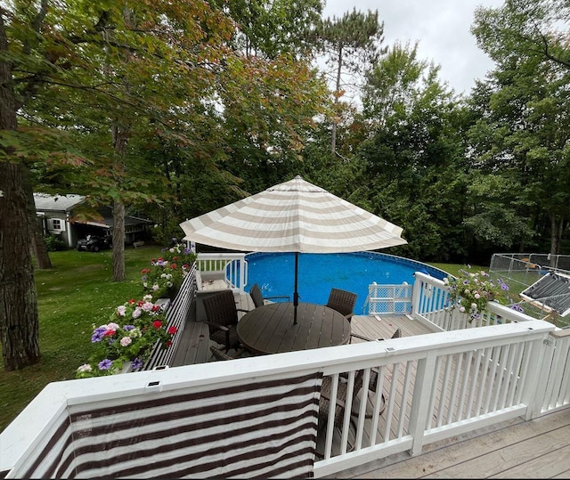 view of swimming pool with a yard and a wooden deck