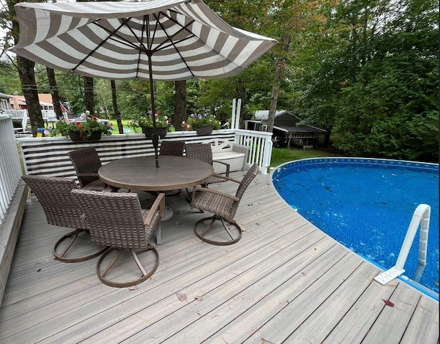 pool featuring outdoor dining space and a deck