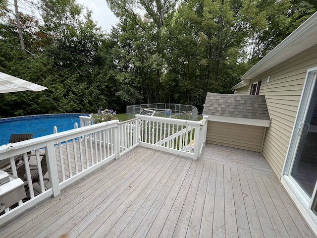 wooden terrace with an outdoor pool