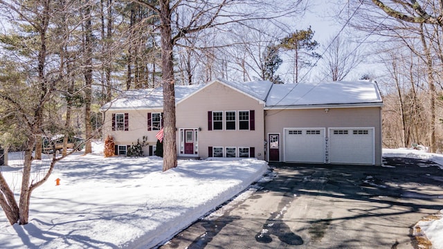 bi-level home with an attached garage and driveway