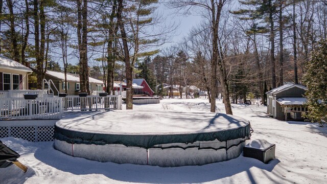 yard covered in snow featuring a wooden deck