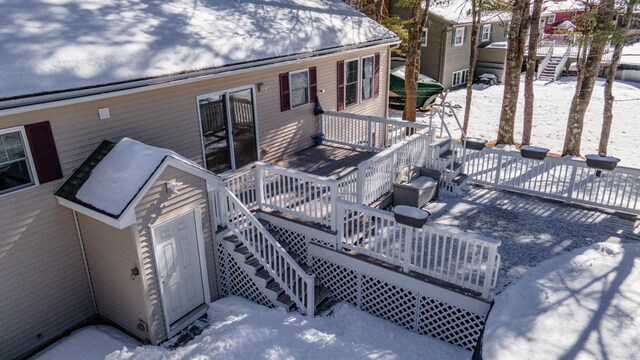 snow covered deck with stairs