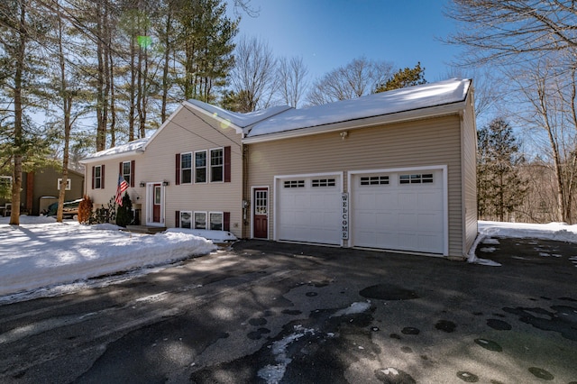 view of front facade with an attached garage, driveway, and entry steps