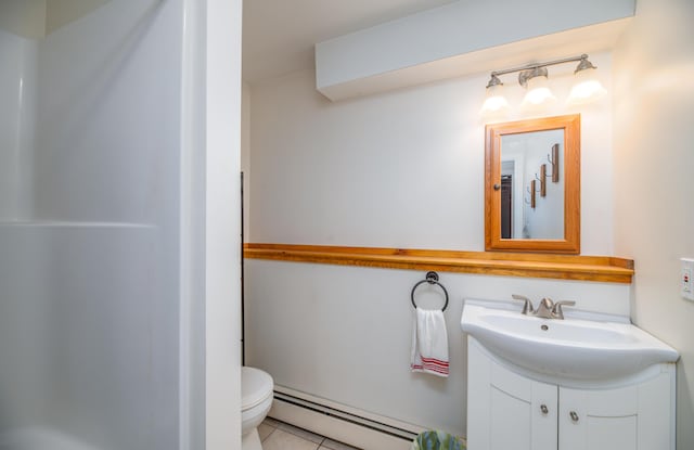 bathroom featuring tile patterned flooring, vanity, toilet, and a baseboard heating unit