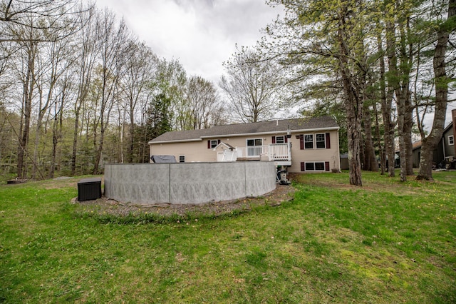 72 Annabessacook Dr, Winthrop, ME 04364 - back of house with central AC unit, a wooden deck, and a lawn