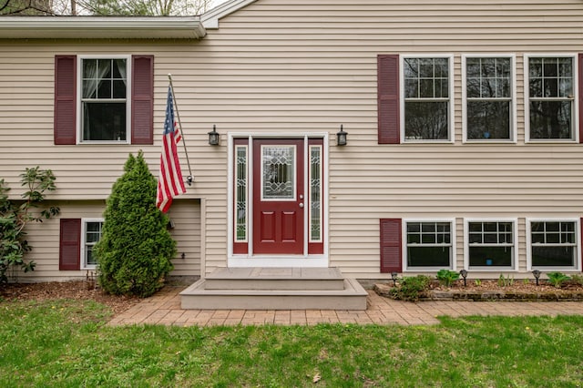 entrance to property featuring a lawn