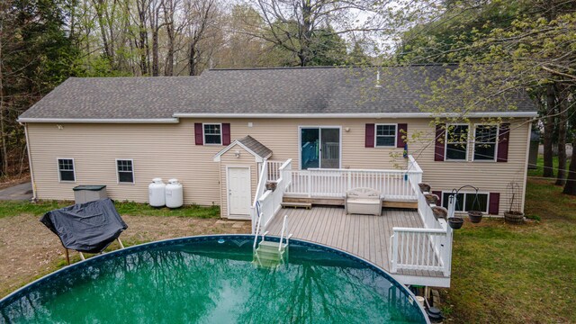 72 Annabessacook Dr, Winthrop, ME 04364 - back of house featuring a deck, an outdoor pool, roof with shingles, and a yard