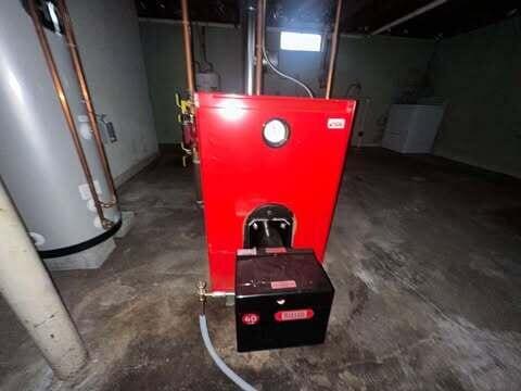 utility room featuring water heater