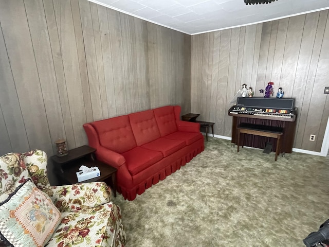 carpeted living room featuring wood walls