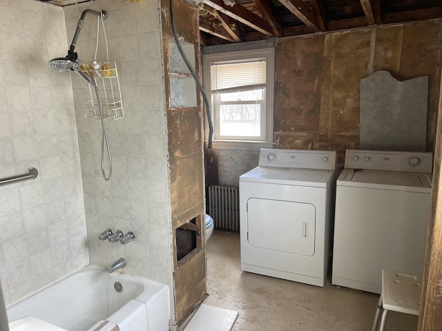 washroom with washer and dryer, radiator, and laundry area