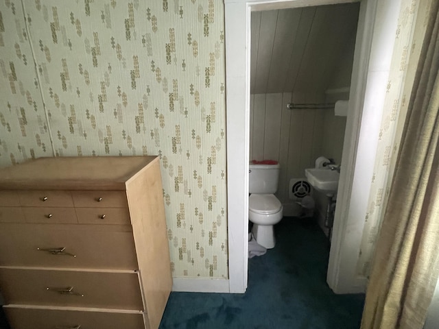 bathroom featuring toilet and wallpapered walls