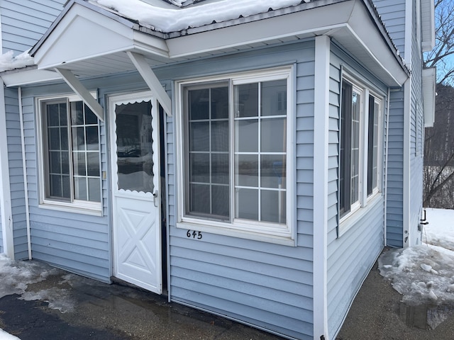 view of exterior entry featuring metal roof