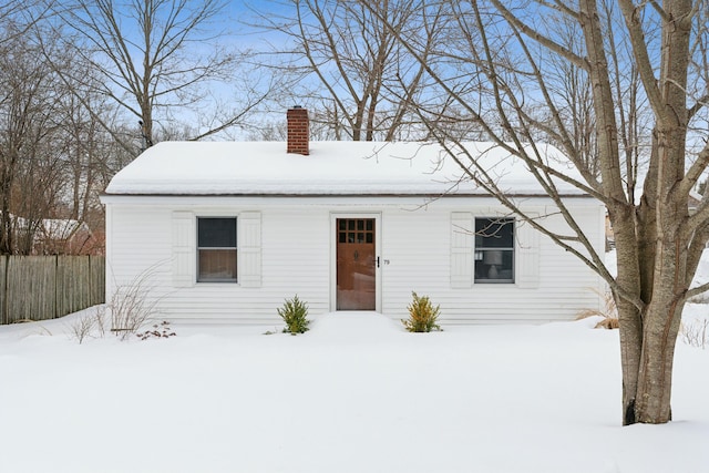 view of front of property with fence and a chimney