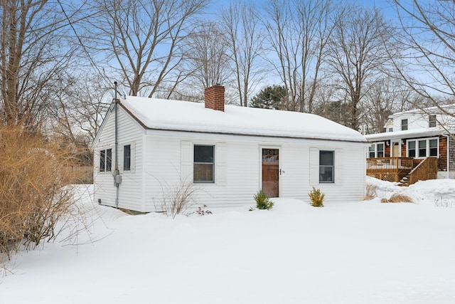 view of front of home featuring a deck and a chimney