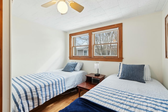 bedroom featuring ceiling fan and wood finished floors