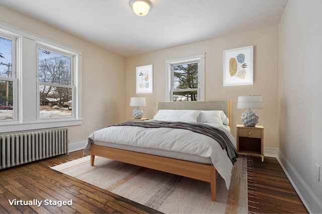 bedroom featuring baseboards, dark wood-style flooring, and radiator