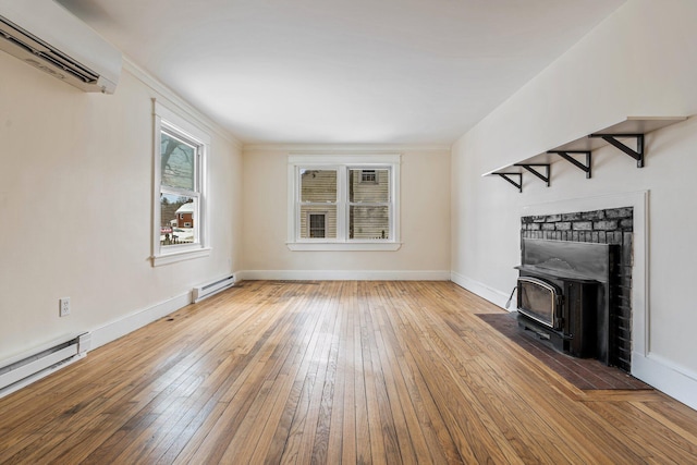 unfurnished living room with hardwood / wood-style flooring, baseboards, baseboard heating, and a wall mounted AC