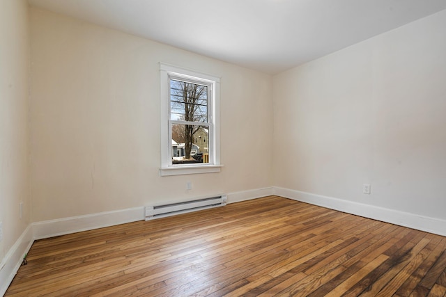 unfurnished room with light wood finished floors, a baseboard radiator, and baseboards