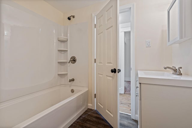 bathroom with vanity, wood finished floors, and shower / bathtub combination