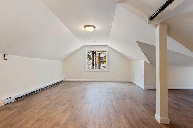 bonus room featuring lofted ceiling, baseboard heating, hardwood / wood-style flooring, and baseboards