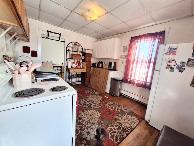 kitchen featuring a paneled ceiling, white appliances, dark wood-style flooring, white cabinetry, and baseboard heating