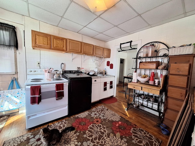 kitchen featuring washer / clothes dryer, white electric range, backsplash, and dark wood-style flooring