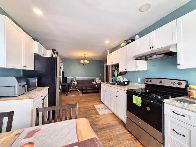 kitchen featuring a chandelier, stainless steel electric range oven, wood finished floors, under cabinet range hood, and white cabinetry