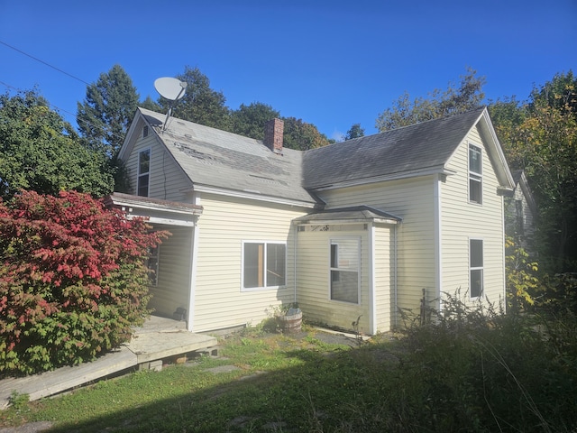 view of property exterior with a chimney