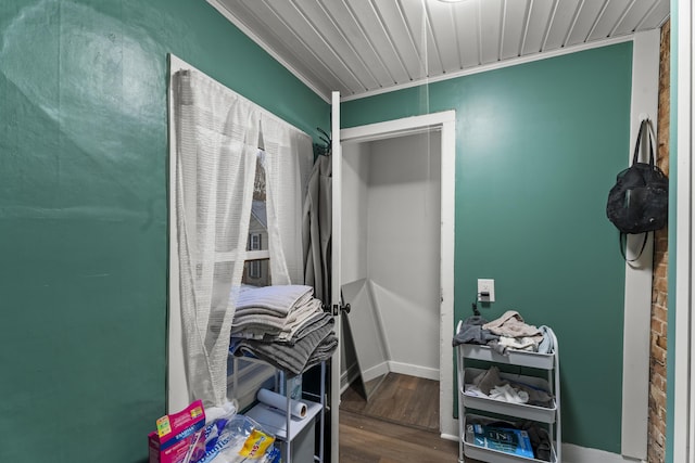 interior space featuring wood ceiling, crown molding, baseboards, and wood finished floors