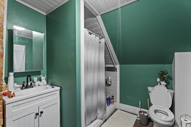 bathroom with baseboards, toilet, a shower stall, and vanity