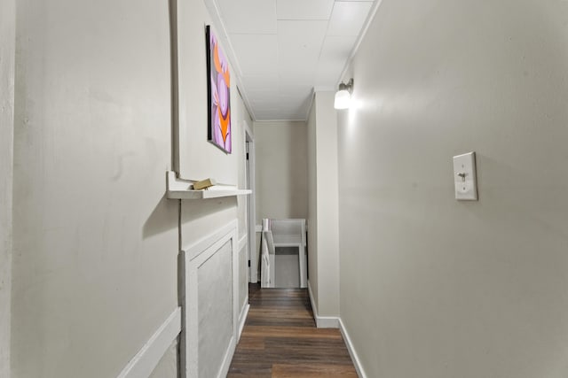 hall featuring baseboards and dark wood-type flooring