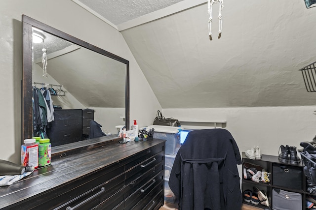 home office featuring vaulted ceiling and a textured ceiling