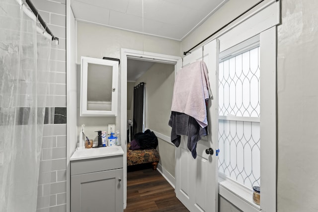 bathroom with wood finished floors and vanity