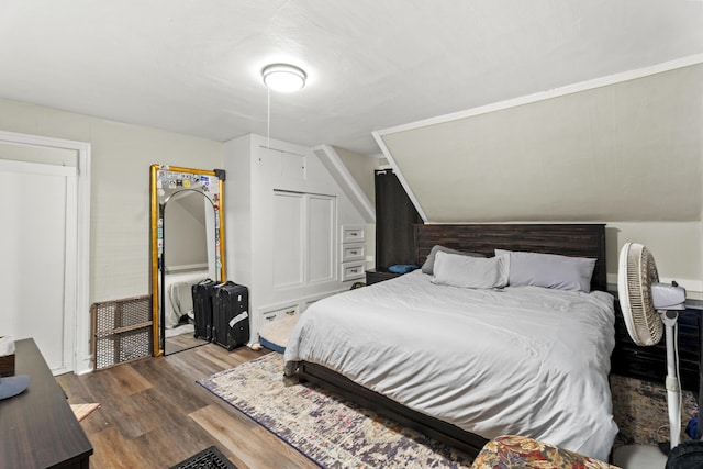 bedroom with lofted ceiling and dark wood-type flooring