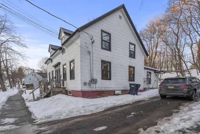 view of snowy exterior featuring metal roof