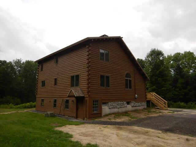 view of side of property featuring stairs, log exterior, and cooling unit