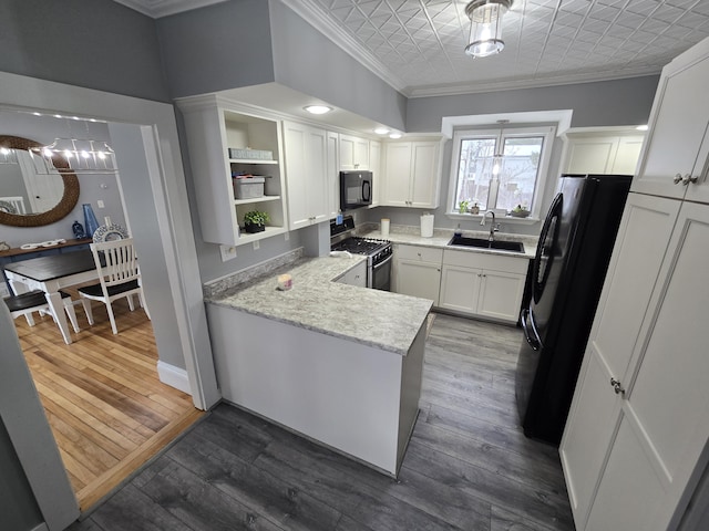 kitchen featuring ornamental molding, a peninsula, black appliances, open shelves, and a sink