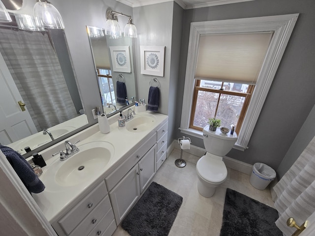 bathroom with baseboards, a sink, and toilet