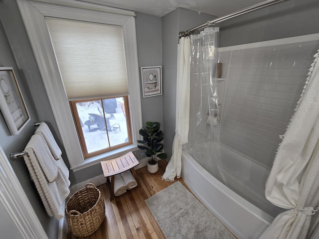 bathroom with shower / tub combo and wood-type flooring