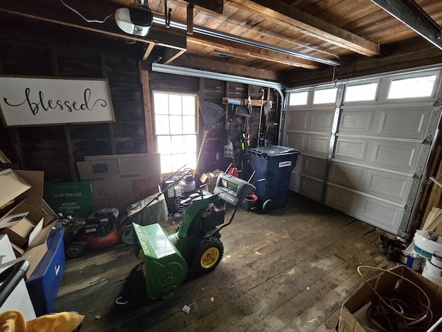 garage featuring a garage door opener and wooden ceiling