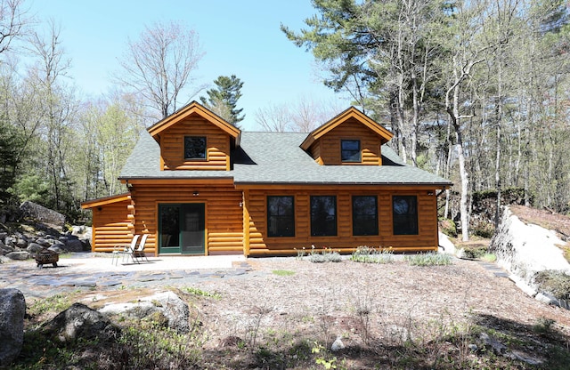 51 Short Point Way, Orland, ME 04472 - log-style house featuring roof with shingles and an outdoor fire pit