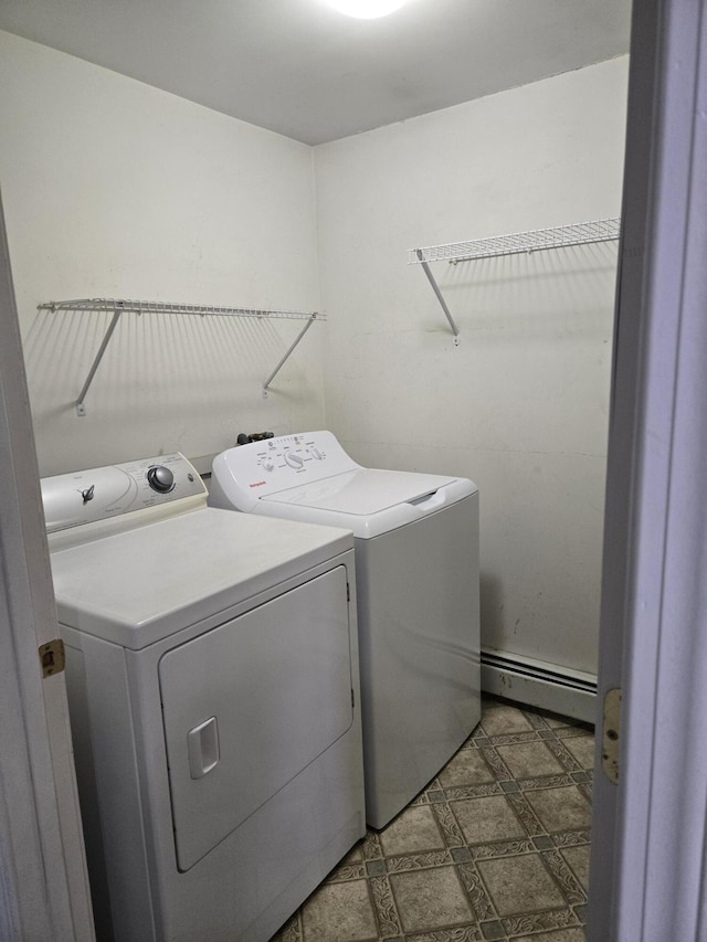 washroom with laundry area, separate washer and dryer, a baseboard radiator, and tile patterned floors