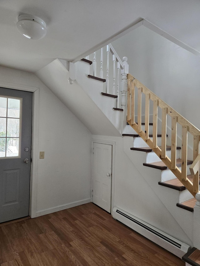 entrance foyer with baseboards, lofted ceiling, wood finished floors, stairs, and a baseboard heating unit