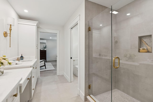 167 Heath Rd, Saco, ME 04072 - bathroom featuring vanity, a wall mounted AC, a stall shower, a baseboard radiator, and recessed lighting