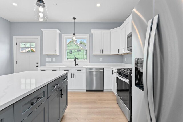 7 Parsonage Rd Unit 5, North Yarmouth, ME 04097 - kitchen with light wood finished floors, hanging light fixtures, stainless steel appliances, light countertops, and a sink