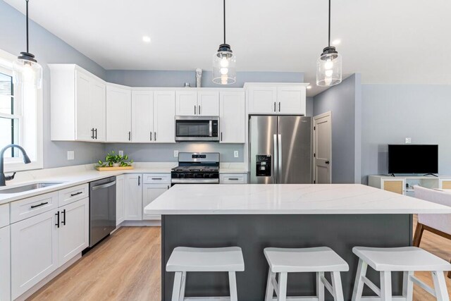 7 Parsonage Rd Unit 5, North Yarmouth, ME 04097 - kitchen with appliances with stainless steel finishes, white cabinetry, a sink, and light wood-style flooring