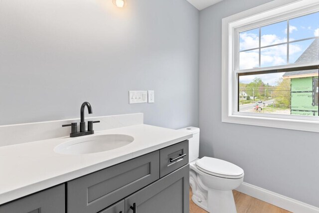 7 Parsonage Rd Unit 5, North Yarmouth, ME 04097 - bathroom featuring a wealth of natural light, baseboards, vanity, and toilet