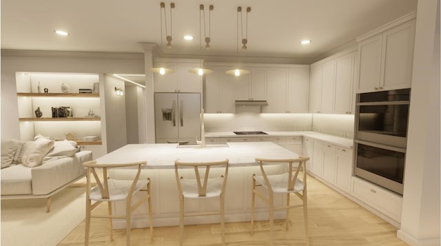 300 N Rd, Yarmouth, ME 04096 - kitchen with stainless steel double oven, gas stovetop, refrigerator with ice dispenser, white cabinets, and a kitchen bar